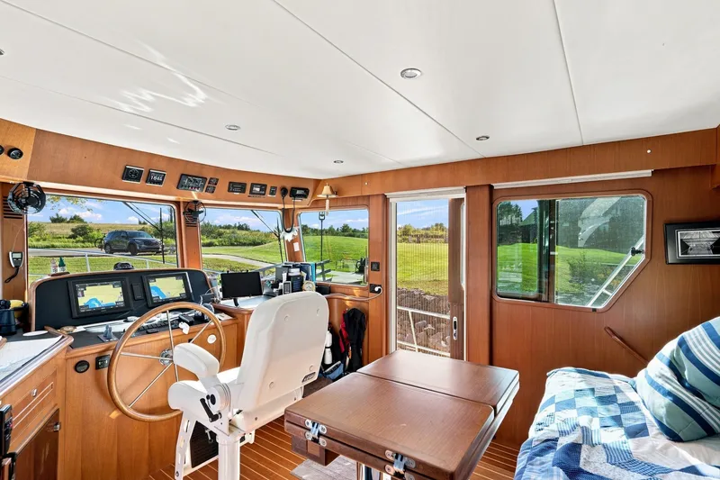 Slide: The Image of Interior of 2015 North Pacific NP49 yacht with helm, navigation equipment, and seating area. - 15