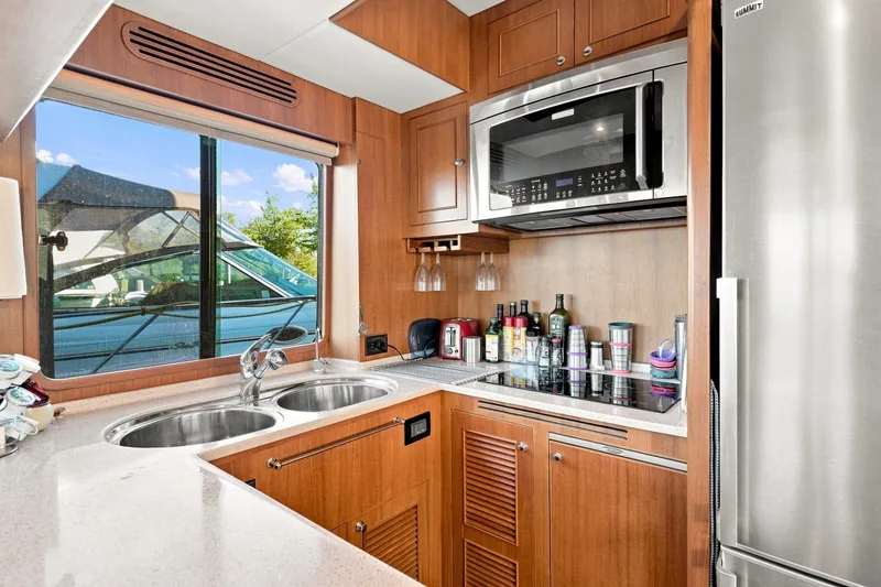 Slide: The Image of Modern kitchen interior on 2015 North Pacific NP49 yacht with appliances and window view. - 11
