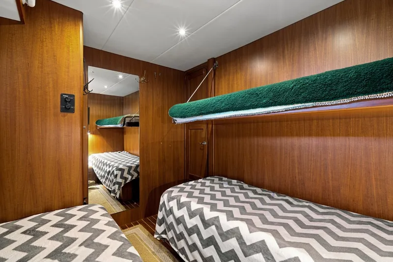 Slide: The Image of Cozy cabin interior of 2015 North Pacific NP49 yacht with bunk beds and wood paneling. - 29