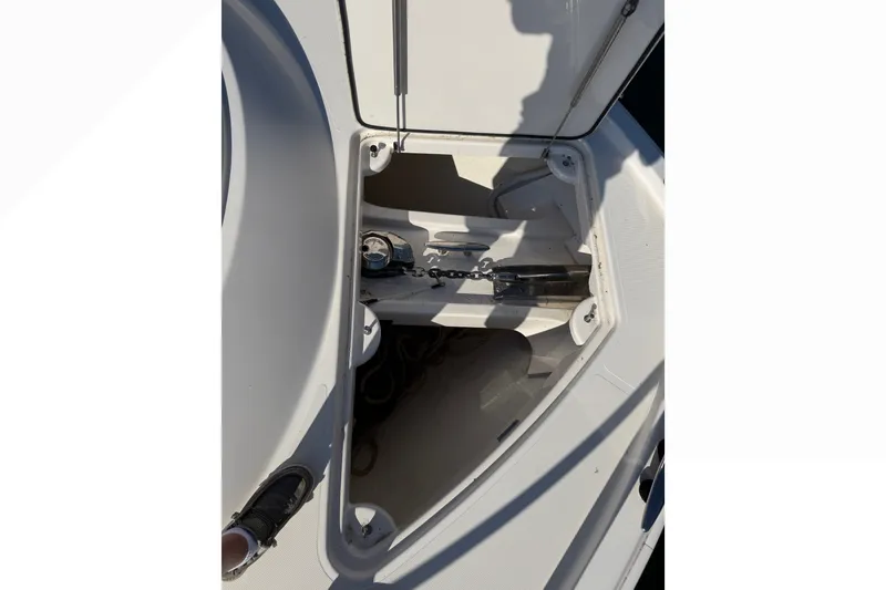 Slide: The Image of Open anchor locker on 2015 Tiara Yachts C44 Coupe, showcasing storage space and equipment. - 47