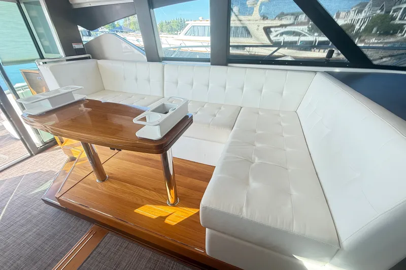 Slide: The Image of Luxurious interior of 2015 Tiara Yachts C44 Coupe with white seating and wooden table. - 32