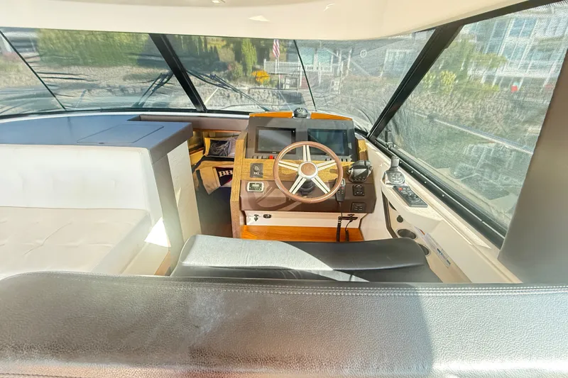 Slide: The Image of Interior view of 2015 Tiara Yachts C44 Coupe helm with steering wheel and navigation controls. - 37