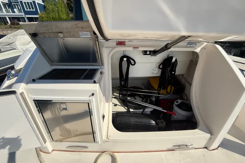 Slide: The Image of Open storage compartment on 2015 Tiara Yachts C44 Coupe, showing equipment and supplies. - 48