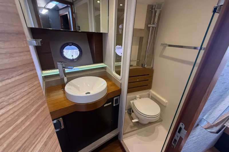 Slide: The Image of Luxurious bathroom in 2015 Tiara Yachts C44 Coupe with modern fixtures and porthole window. - 19