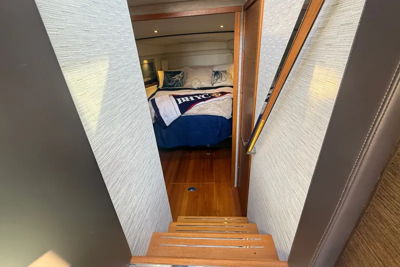 Slide: The Image of Interior cabin view of 2015 Tiara Yachts C44 Coupe, featuring cozy bedding and wooden flooring. - 28