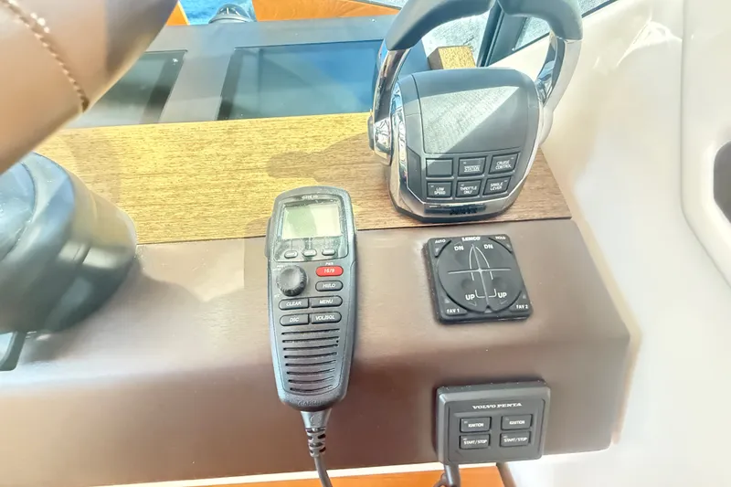 Slide: The Image of Control panel of a 2015 Tiara Yachts C44 Coupe with throttle and communication device. - 33
