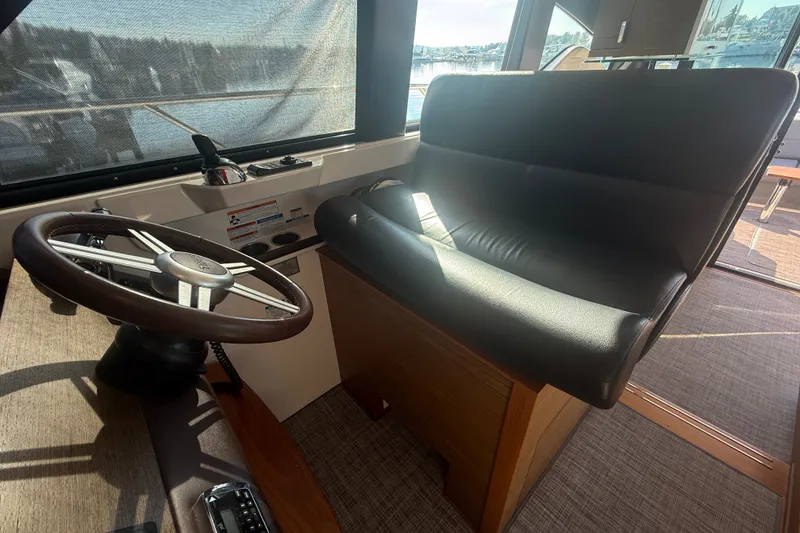 Slide: The Image of Interior helm of 2015 Tiara Yachts C44 Coupe with steering wheel and seating. - 35