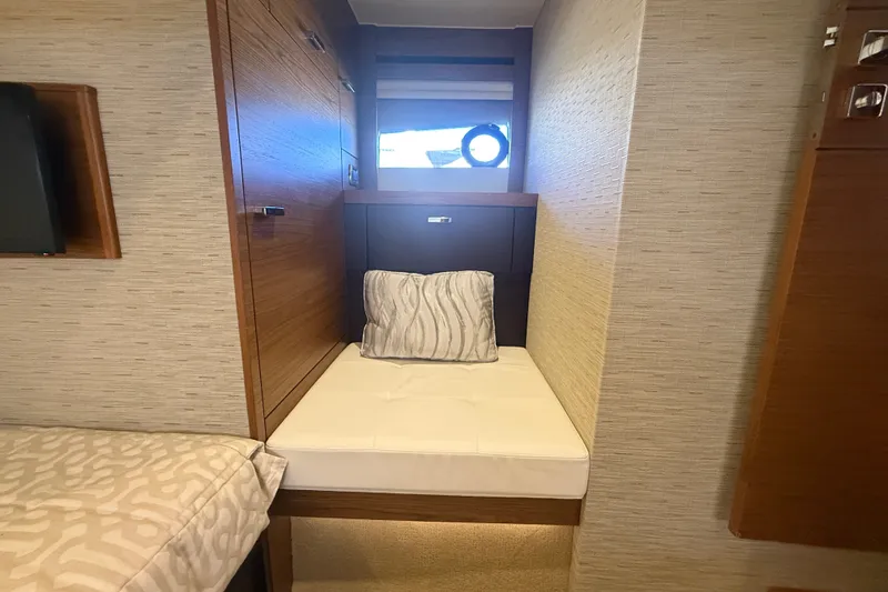 Slide: The Image of Cozy cabin interior of 2015 Tiara Yachts C44 Coupe with wooden accents and plush bedding. - 23
