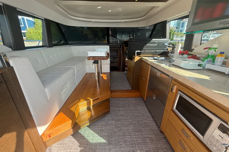 Slide: The Image of Interior of 2015 Tiara Yachts C44 Coupe with modern kitchen and seating area. - 40
