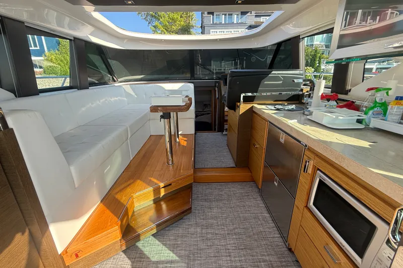 Slide: The Image of Interior of 2015 Tiara Yachts C44 Coupe with modern kitchen and seating area. - 27