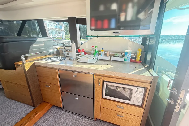 Slide: The Image of Modern kitchen area in a 2015 Tiara Yachts C44 Coupe, featuring sleek cabinetry and appliances. - 38