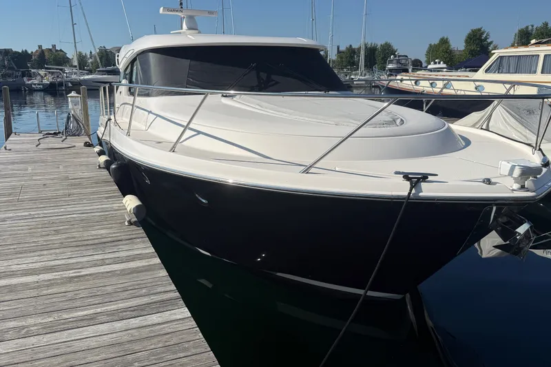 The Image of 2015 Tiara Yachts C44 Coupe docked at marina, sleek design, sunny day. - 0