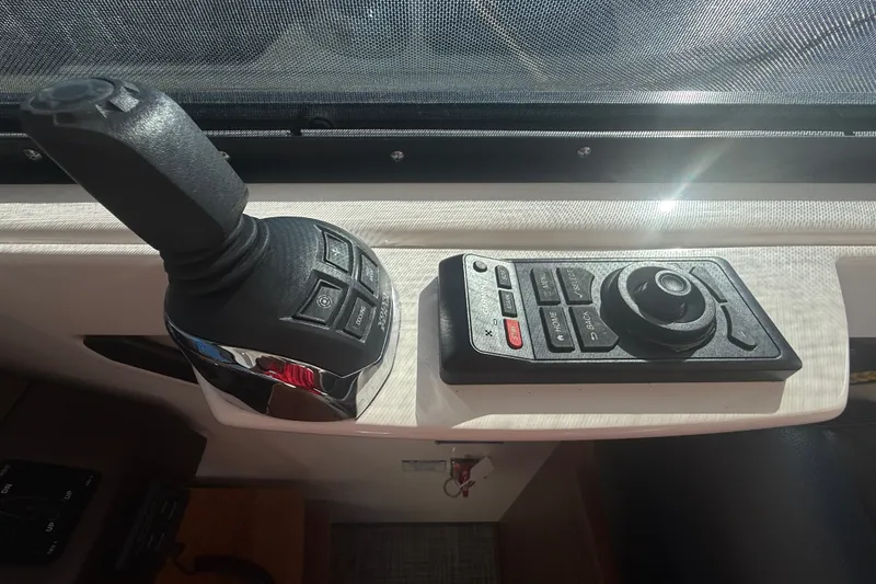 Slide: The Image of Control panel of a 2015 Tiara Yachts C44 Coupe, featuring joystick and remote. - 34