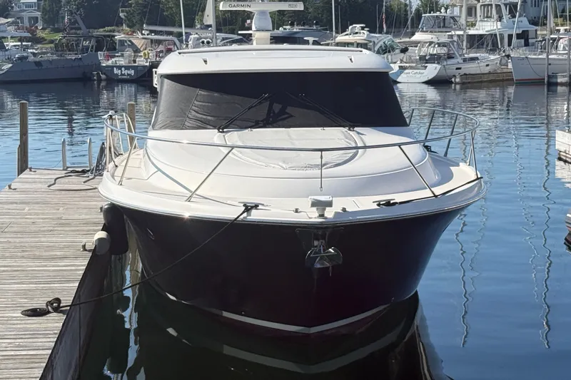 Slide: The Image of 2015 Tiara Yachts C44 Coupe docked at a marina, front view. - 1