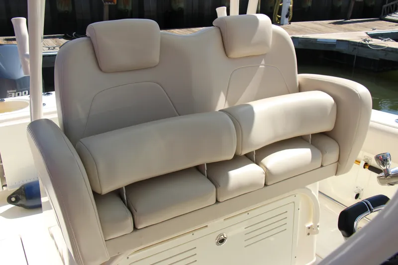 Slide: The Image of 2015 Cobia 296 Center Console boat with beige cushioned seating. - 16