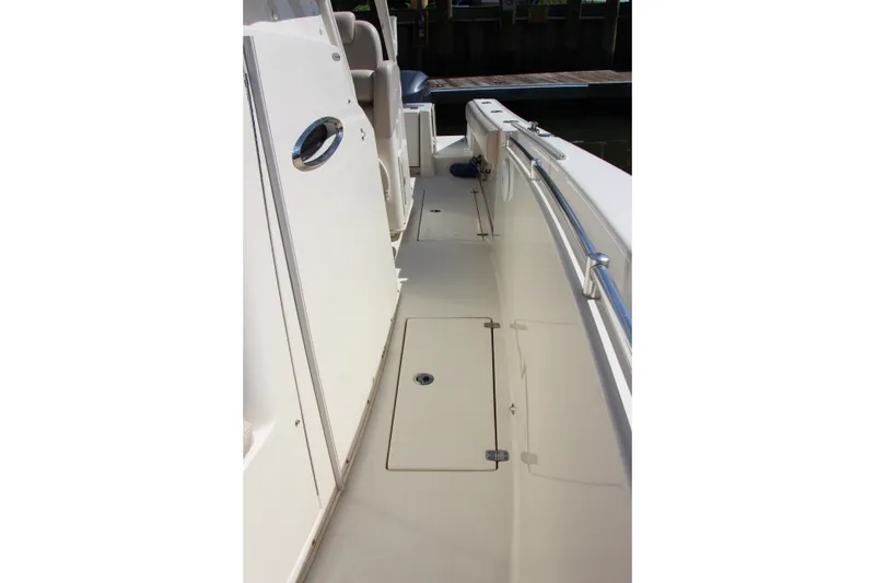 Slide: The Image of 2015 Cobia 296 Center Console boat deck with storage hatch and railing. - 13