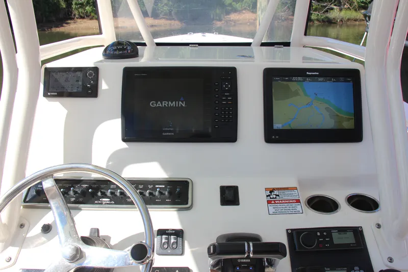 Slide: The Image of 2015 Cobia 296 Center Console dashboard with Garmin and Raymarine navigation displays. - 24