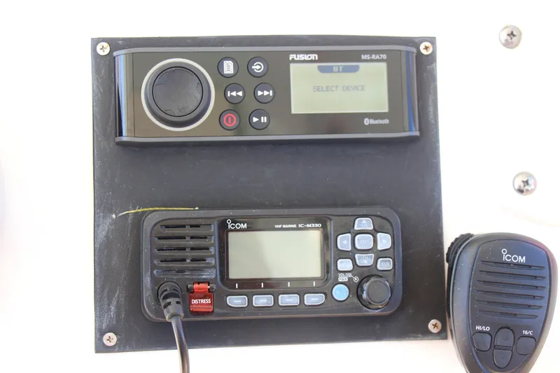 Slide: The Image of Fusion and Icom marine electronics on 2015 Cobia 296 Center Console boat dashboard. - 26