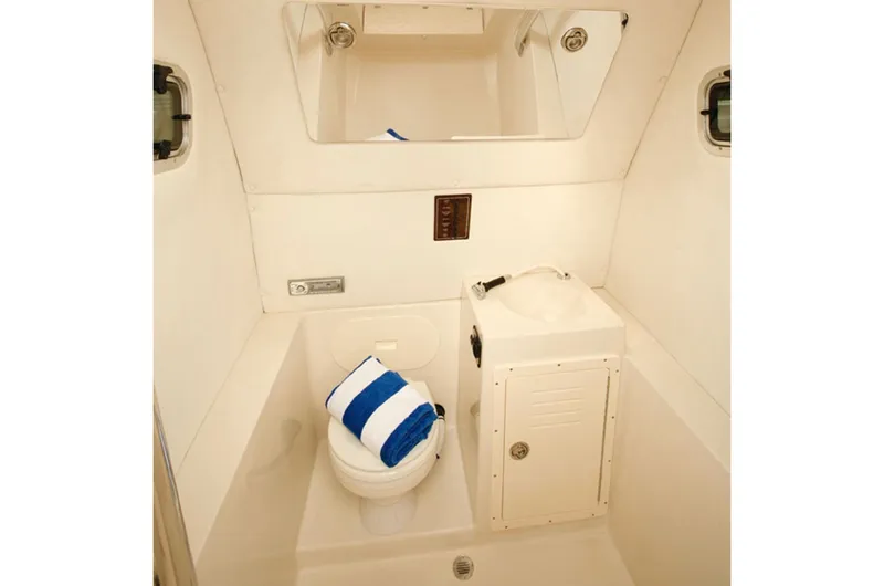 Slide: The Image of Manufacturer Provided Image: 2015 Cobia 296 Center Console boat bathroom with toilet and sink. - 31