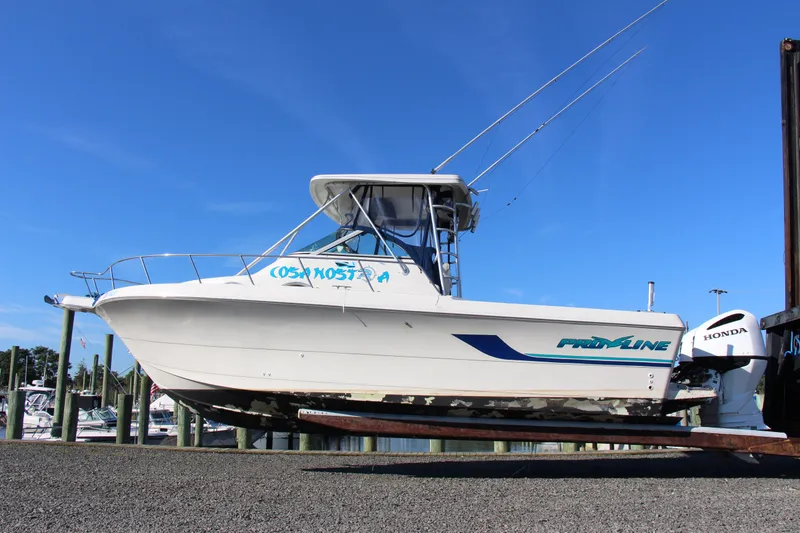 The Image of 1996 Pro-Line 2950 Walkaround boat on trailer, with clear blue sky background. - 1