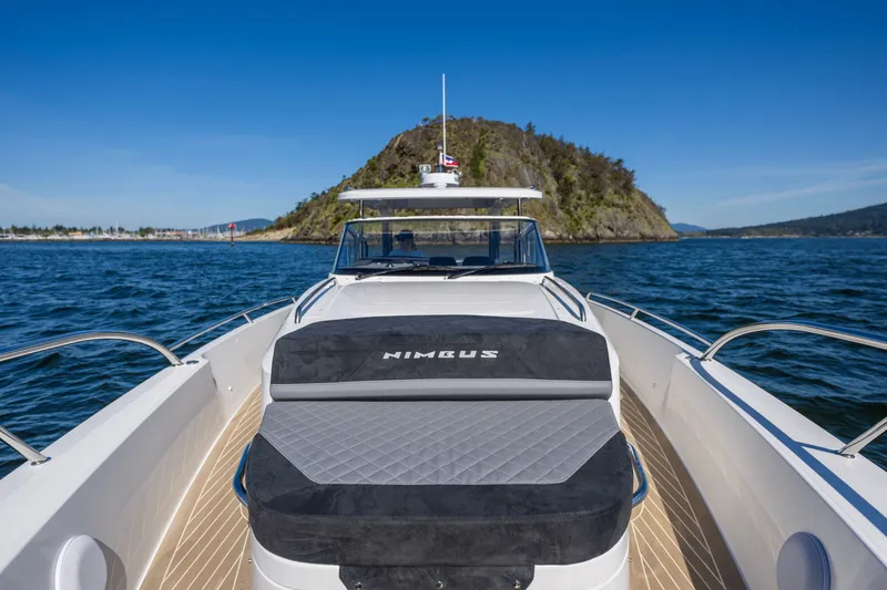 Slide: The Image of 2023 Nimbus Tender 11 cruising on open water with scenic island backdrop. - 5