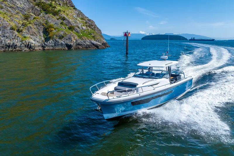 Slide: The Image of 2023 Nimbus Tender 11 cruising in scenic coastal waters. - 17