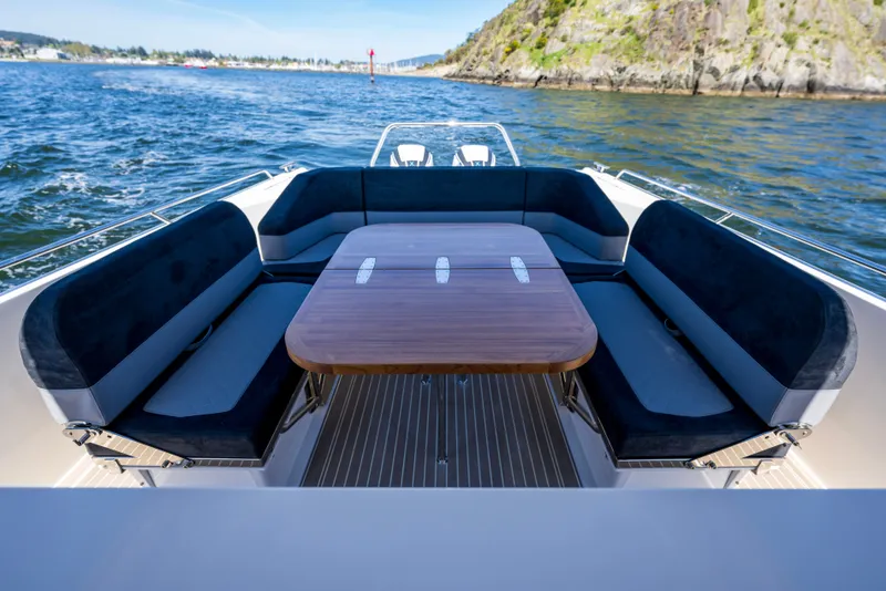 Slide: The Image of Luxurious seating area on 2023 Nimbus Tender 11 boat with scenic ocean view. - 2