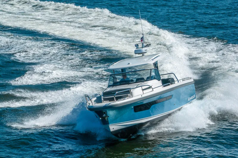 Slide: The Image of 2023 Nimbus Tender 11 cruising swiftly on open water, creating dynamic waves. - 14