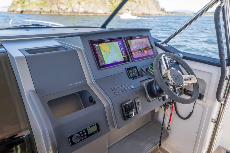 Slide: The Image of Cockpit of 2023 Nimbus Tender 11 with modern navigation displays and steering wheel. - 3
