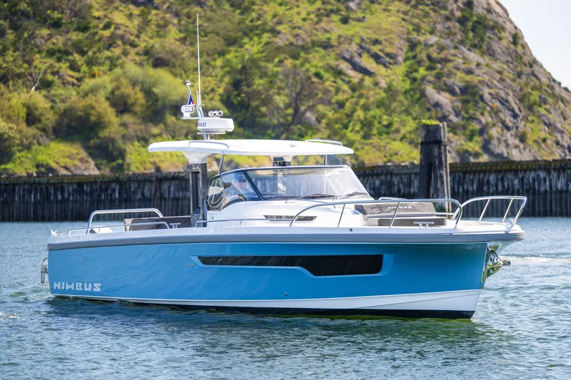 Slide: The Image of 2023 Nimbus Tender 11 boat on water with scenic rocky background. - 11