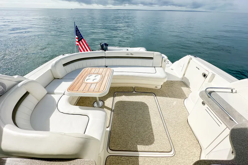 Slide: The Image of Luxurious 2006 Sea Ray 48 Sundancer yacht deck with seating and American flag. - 43