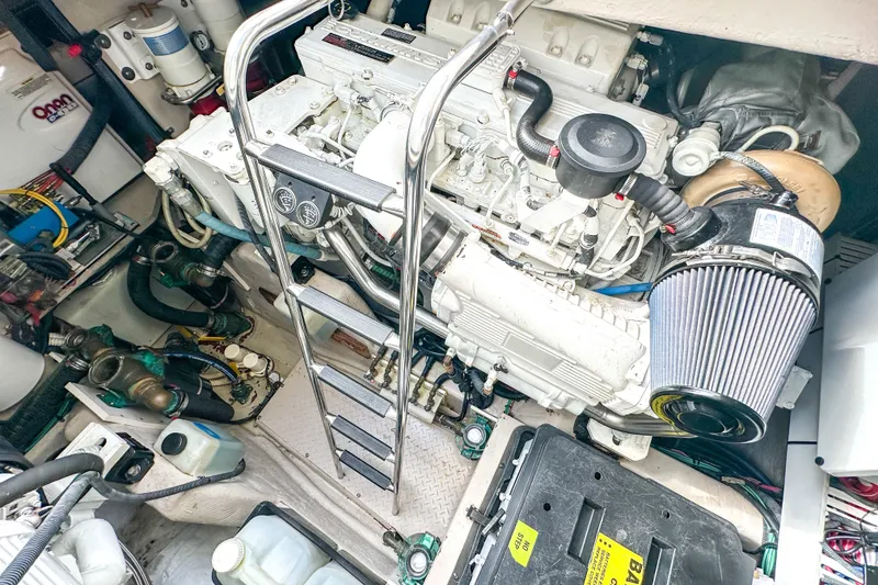 Slide: The Image of Engine room of a 2006 Sea Ray 48 Sundancer yacht, showcasing mechanical components and ladder. - 86