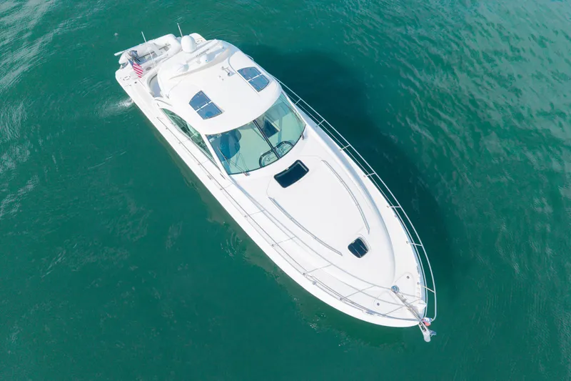 Slide: The Image of Aerial view of a 2006 Sea Ray 48 Sundancer yacht on clear blue water. - 31