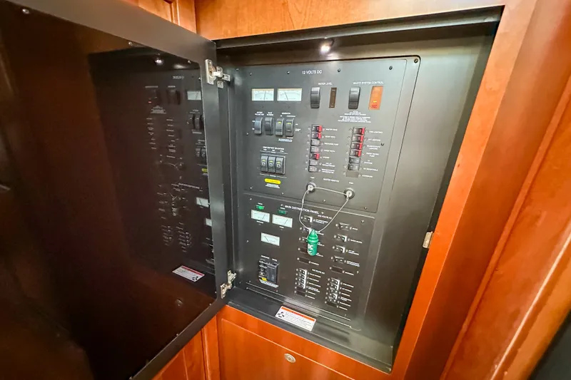 Slide: The Image of Electrical control panel inside 2006 Sea Ray 48 Sundancer yacht, featuring switches and indicators. - 75