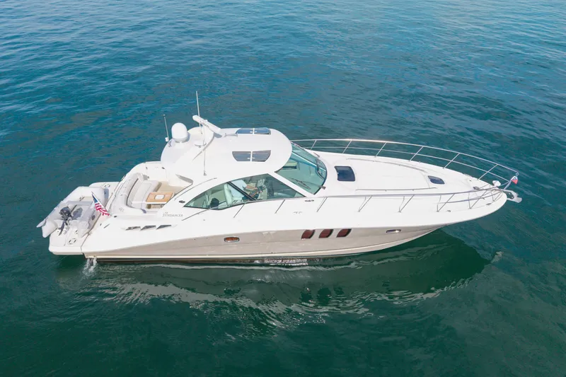 Slide: The Image of 2006 Sea Ray 48 Sundancer yacht cruising on open water. - 28