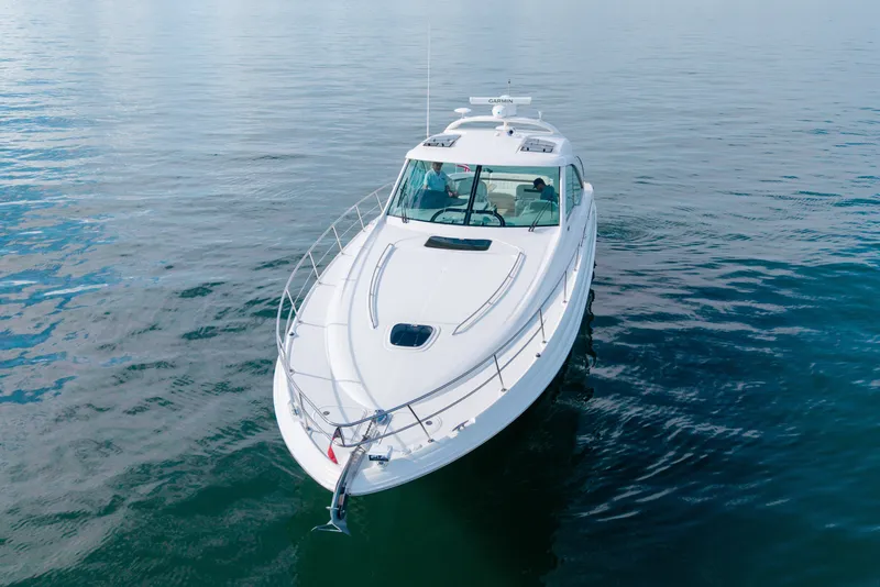 Slide: The Image of 2006 Sea Ray 48 Sundancer yacht cruising on calm waters. - 24