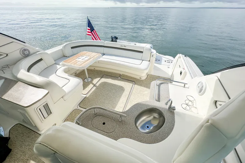 Slide: The Image of Luxurious 2006 Sea Ray 48 Sundancer yacht interior with seating, table, and ocean view. - 42