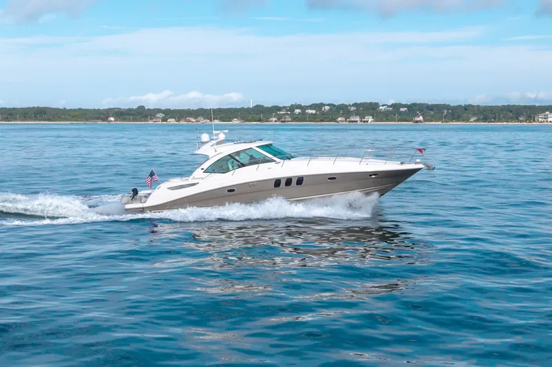 Slide: The Image of 2006 Sea Ray 48 Sundancer cruising on calm blue waters. - 1
