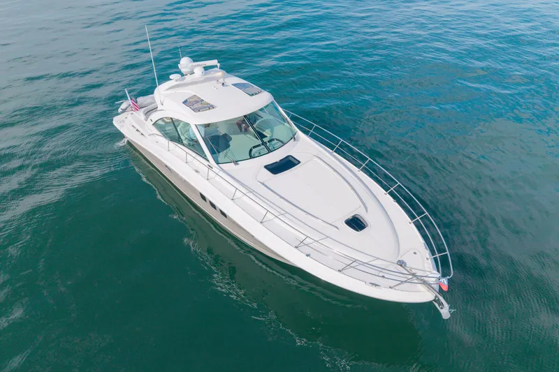 Slide: The Image of 2006 Sea Ray 48 Sundancer yacht cruising on calm blue waters. - 30