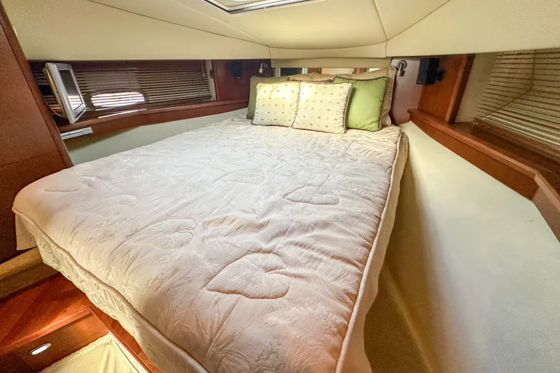 Slide: The Image of Luxurious bedroom interior of 2006 Sea Ray 48 Sundancer yacht with cozy bedding. - 70