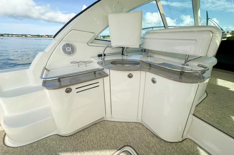 Slide: The Image of Luxurious 2006 Sea Ray 48 Sundancer yacht interior with sleek kitchenette and seating area. - 45