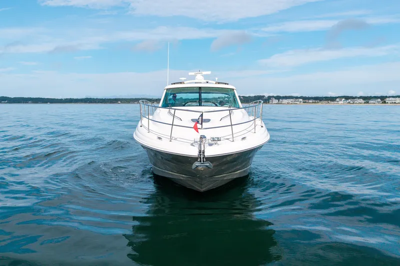 Slide: The Image of 2006 Sea Ray 48 Sundancer yacht cruising on calm blue waters. - 14