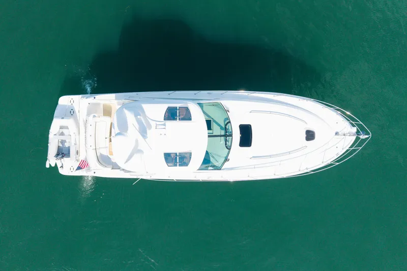 Slide: The Image of Aerial view of 2006 Sea Ray 48 Sundancer yacht on clear water. - 32