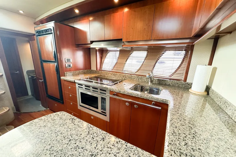 Slide: The Image of Luxurious kitchen interior of 2006 Sea Ray 48 Sundancer yacht with granite countertops. - 64