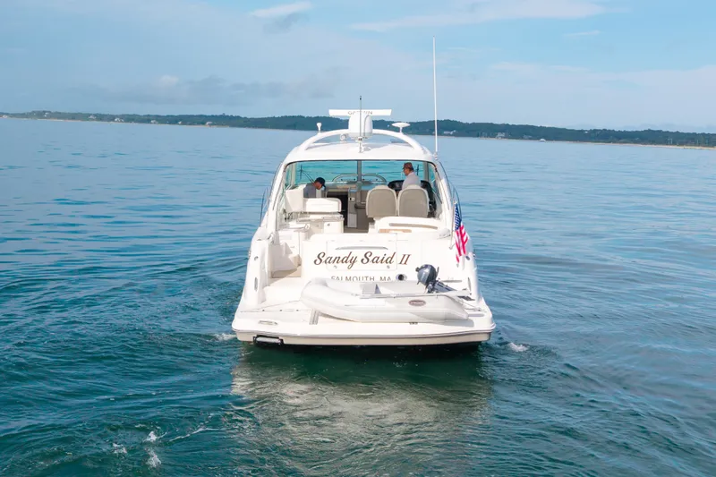 Slide: The Image of 2006 Sea Ray 48 Sundancer yacht cruising on calm waters, rear view. - 11