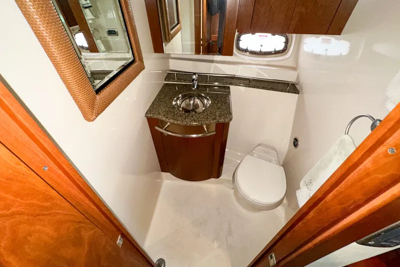 Slide: The Image of Luxurious bathroom in 2006 Sea Ray 48 Sundancer yacht with granite countertop and wooden cabinetry. - 73
