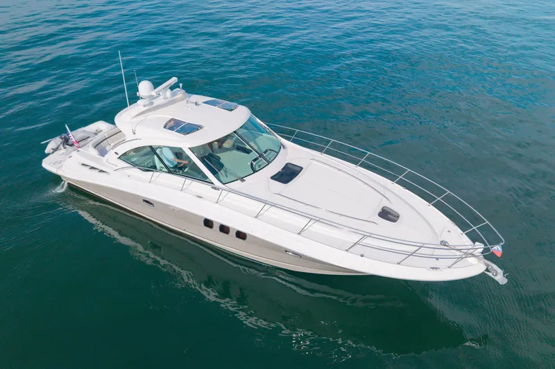 Slide: The Image of 2006 Sea Ray 48 Sundancer yacht cruising on calm blue waters. - 29