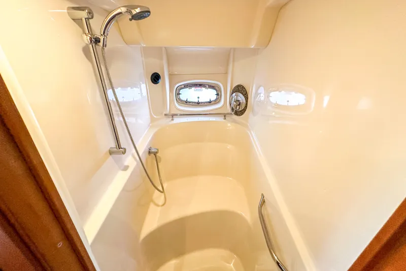 Slide: The Image of Luxurious bathroom in 2006 Sea Ray 48 Sundancer yacht with shower and porthole window. - 72