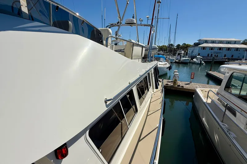 Slide: The Image of 2015 Coastal Craft 45 yacht docked at marina, surrounded by other boats. - 24