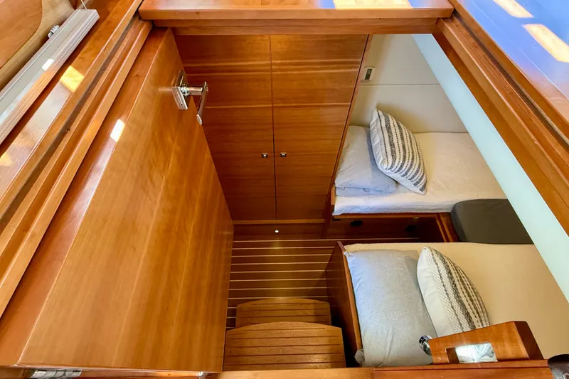 Slide: The Image of 2015 Coastal Craft 45 yacht cabin with wooden interior and twin beds. - 66